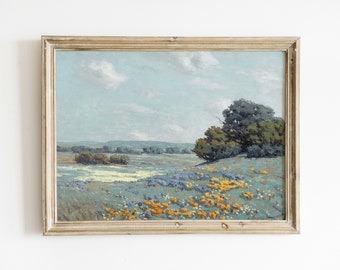 May include: A framed landscape painting depicting a field of wildflowers in shades of blue, yellow, and white. The field is set against a backdrop of rolling hills and a blue sky with fluffy clouds.