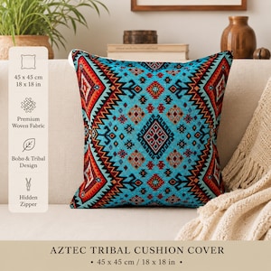 May include: A square cushion cover with an Aztec tribal design, measuring 45 x 45 cm. It features a turquoise base with a geometric pattern in red, orange, and black. The design includes diamond and zigzag motifs. Made of woven fabric.