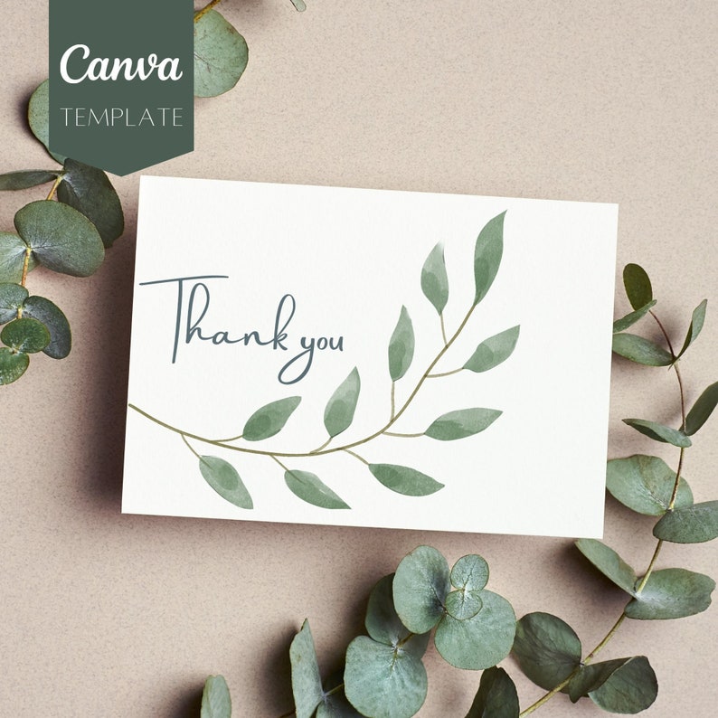 May include: A white card with the text "Thank you" written in black script. The card is decorated with a watercolor illustration of a green leafy branch.