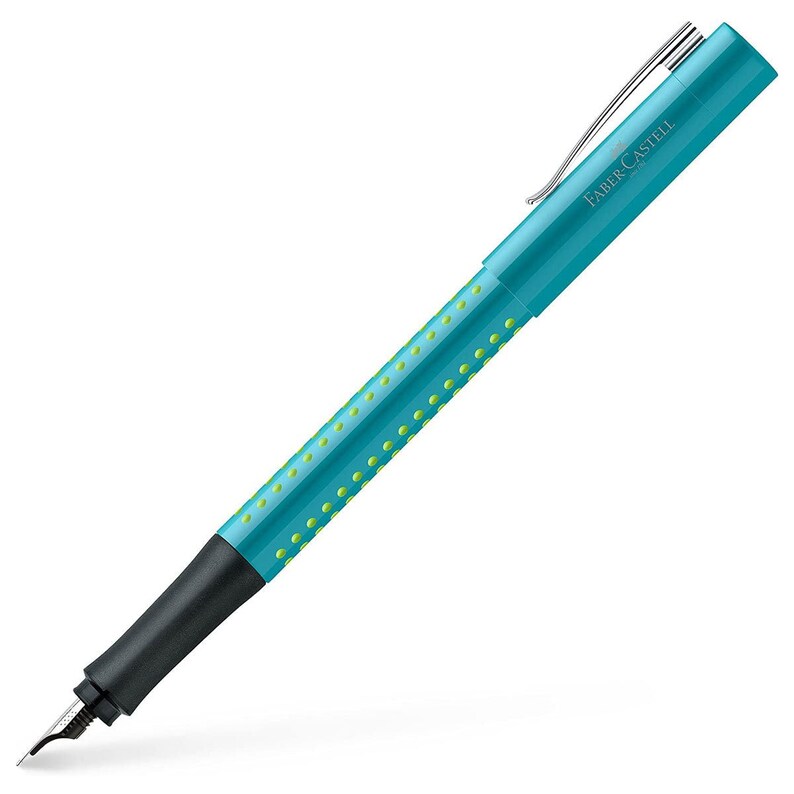 May include: A turquoise blue fountain pen with a black grip and a green dot pattern. The pen has a silver clip and the brand name "Faber-Castell" is printed on the side.