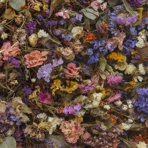 May include: A close-up view of a mix of dried flowers in various colors. The arrangement includes purple, pink, yellow, and white flowers, along with green leaves and brown stems. The flowers are densely packed together.