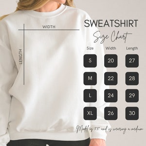 May include: A white sweatshirt with a size chart. The chart shows measurements for sizes S, M, L, and XL. Width measurements range from 20 to 26 inches, and length measurements range from 27 to 30 inches.