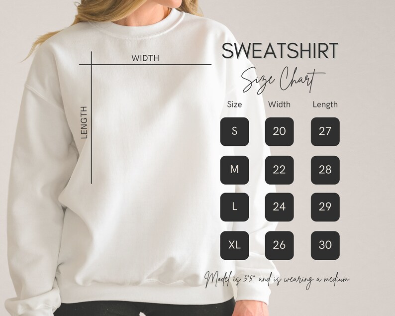 May include: A white sweatshirt with a size chart. The chart shows measurements for sizes S, M, L, and XL. Width measurements range from 20 to 26 inches, and length measurements range from 27 to 30 inches.