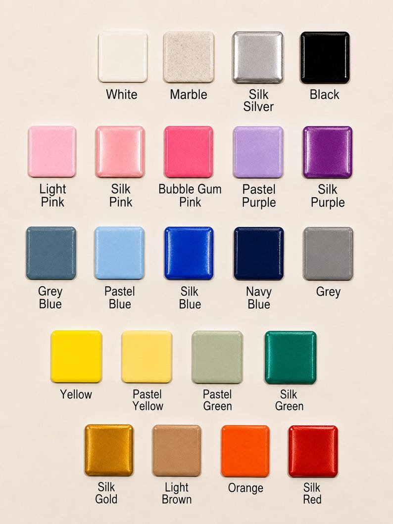 May include: A color chart featuring twenty-two square tiles arranged in rows. Each tile displays a distinct color or finish, including white, marble, silk silver, black, light pink, silk pink, bubble gum pink, pastel purple, silk purple, grey blue, pastel blue, silk blue, navy blue, grey, yellow, pastel yellow, pastel green, silk green, silk gold, light brown, orange, and silk red, with the corresponding name printed below each.