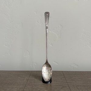 May include: Silver souvenir spoon with a design of the Empire State Building and the text "New York World's Fair 1939" on the bowl.