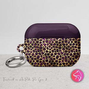 May include: A purple and gold leopard print AirPods Pro Gen 2 case with a silver carabiner clip. The case features a dark purple top and a gold base with purple and black spots. The text "Featured on AirPods Pro Gen 2" is visible.