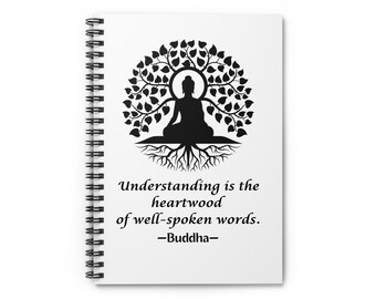 May include: White spiral-bound notebook with a black silhouette of a seated Buddha under a tree. The text "Understanding is the heartwood of well-spoken words. -Buddha-" is printed below the image.