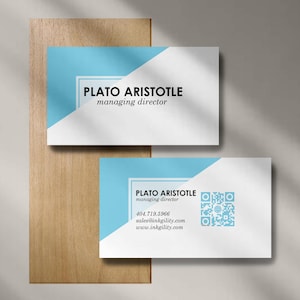 May include: Two business cards with a blue and white diagonal design. The text "PLATO ARISTOTLE managing director" is printed on the cards. One card includes a QR code, phone number, and website address.