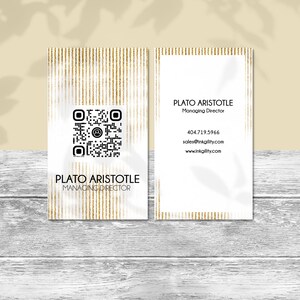 May include: Two business cards with a gold and white design. The front card has a QR code and the name "Plato Aristotle, Managing Director." The back card has contact information including a phone number and website.