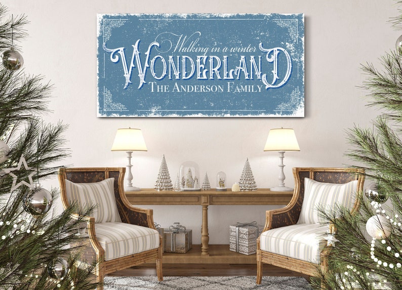 May include: A blue and white canvas print with the text "Walking in a winter WONDERLAND The ANDERSON FAMILY" in a vintage style font.