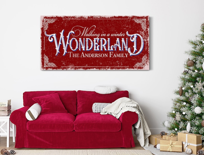 May include: Red and white canvas sign with the text "Walking in a winter WONDERLAND THE ANDERSON FAMILY" in a vintage style font.