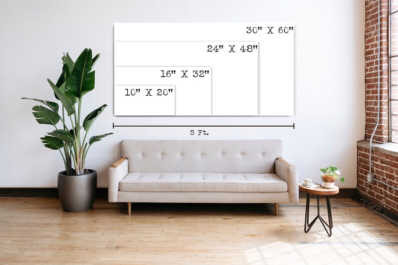 May include: A white wall with a couch in front of it. The wall has four rectangular frames with different sizes and dimensions written on them. The dimensions are 30" x 60", 24" x 48", 16" x 32", and 10" x 20". The couch is a light gray color and has a wooden frame. There is a small table with a plant on it to the right of the couch.