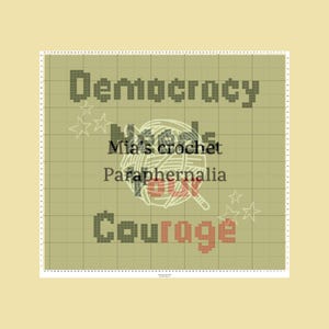 May include: A cross-stitch pattern with the words "Democracy" and "Courage" in pixelated font. The text "Mia's crochet Paraphernalia" is also present, along with a yarn ball graphic and star accents. The background is a grid pattern.