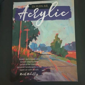 May include: A softcover instructional book titled En Plein Air Acrylic by Mark Mehaffey. The cover features an impressionistic landscape painting of a road with trees and utility poles, rendered in shades of green, blue, orange, and purple.