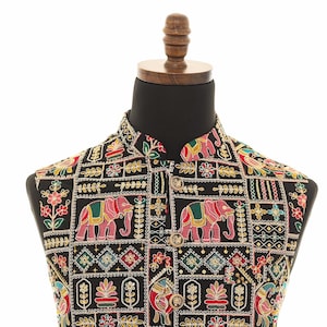 May include: A black waistcoat with a colorful embroidered pattern featuring elephants, flowers, and geometric designs.