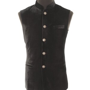 May include: A black velvet waistcoat with a mandarin collar and silver buttons.