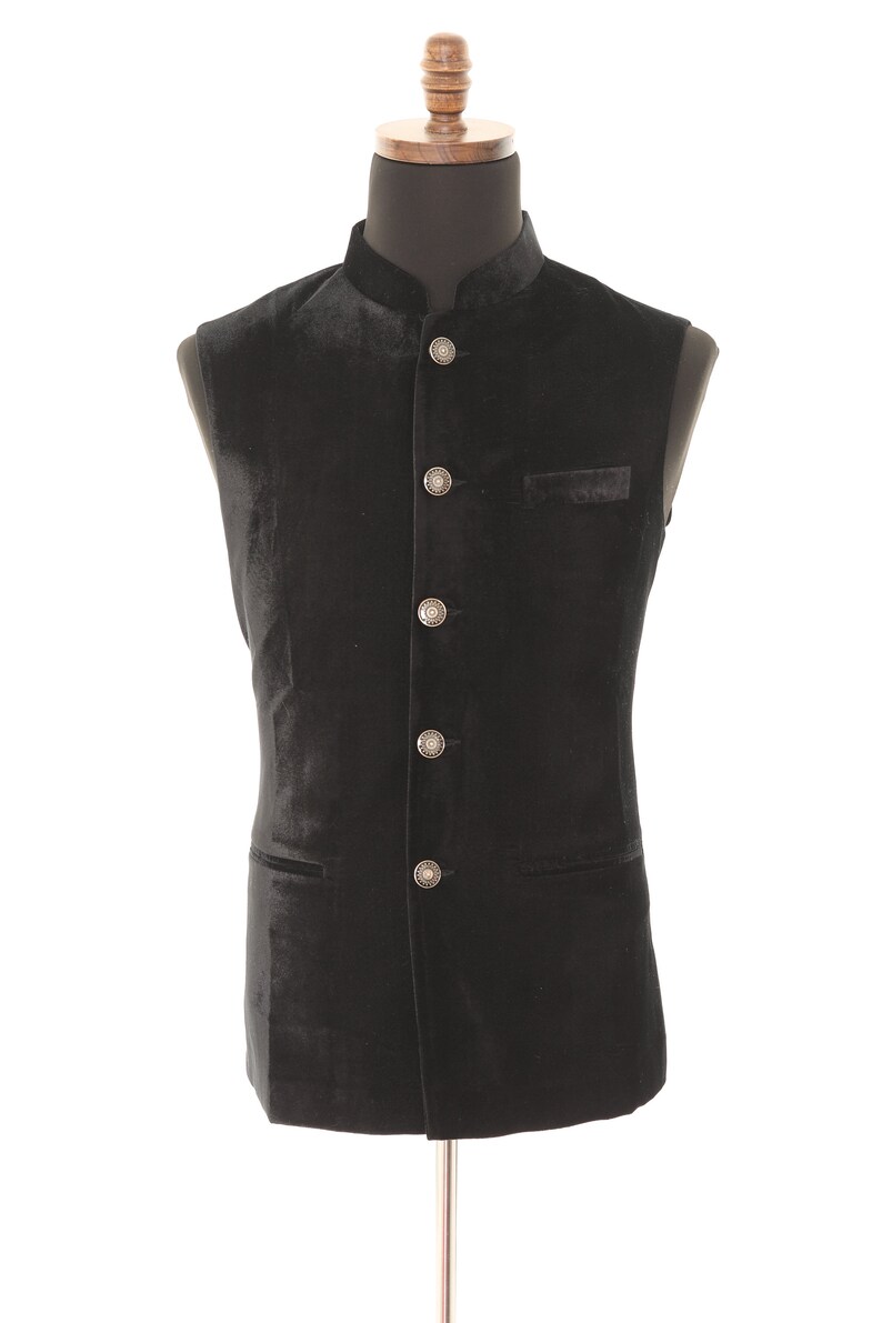 May include: A black velvet waistcoat with a mandarin collar and silver buttons.