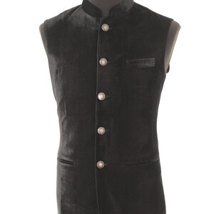 May include: A black velvet waistcoat with a mandarin collar and silver buttons.