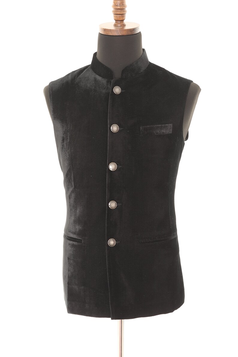 May include: A black velvet waistcoat with a mandarin collar and silver buttons.