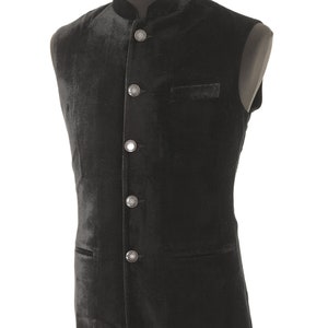 May include: A black velvet waistcoat with a mandarin collar and five silver buttons. The waistcoat has two pockets.