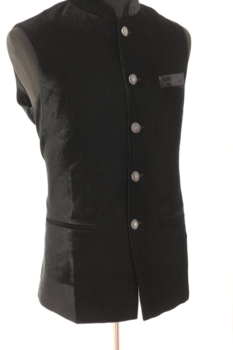 May include: A black velvet waistcoat with a mandarin collar and silver buttons.