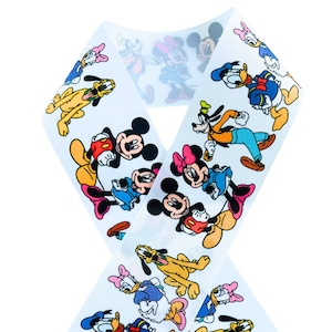 May include: A white ribbon-shaped accessory featuring a repeating pattern of cartoon characters, including Mickey Mouse, Minnie Mouse, Donald Duck, and Goofy. The characters are in various poses and outfits, with a light blue background.