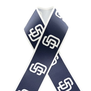 May include: Navy blue ribbon with a repeating white logo pattern. The ribbon is folded into a loop, showcasing the design. The edges are finished with a white trim, creating a clean, contrasting border.