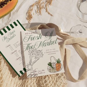 May include: A white invitation card with green and black stripes on the left side and a handwritten invitation for a bachelorette weekend. The invitation reads "Abigail's Fresh Off The Market" with a drawing of a bouquet of flowers and a grocery bag with carrots and a head of garlic. The text also reads "Join us for a bachelorette weekend" and "June 6th - June 8th, Oceanside, California."