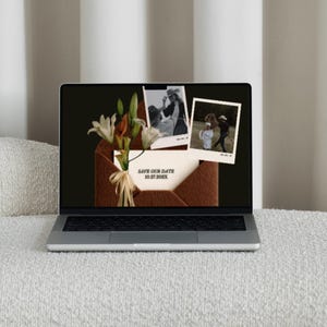 May include: A laptop displays a wedding invitation design. The screen shows a brown envelope with flowers, two black and white photos, and a card that reads "Save Our Date 10.27.2025". The laptop is on a white textured surface.