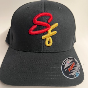 May include: Black baseball cap with a red and gold embroidered "SF" logo. The cap has a Flexfit label on the back.