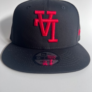 May include: A black and red New Era 9FIFTY snapback hat with a red "LA" logo.