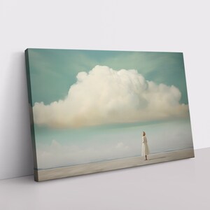 A girl stands under a calming fluffy cloud in the middle of nowhere in this minimalist, abstract painting on a framed and ready-to-hang canvas.