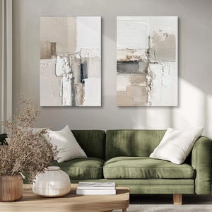 May include: Two vertical rectangular wall art pieces featuring abstract compositions with thick, layered impasto paint textures in neutral shades of white, cream, beige, taupe, and charcoal gray, displayed side by side on a plain wall.