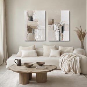 Beige and ivory abstract canvas bundle with wood coffee table, in a modern Scandinavian inspired minimalist living room, inspiring calm and serenity.