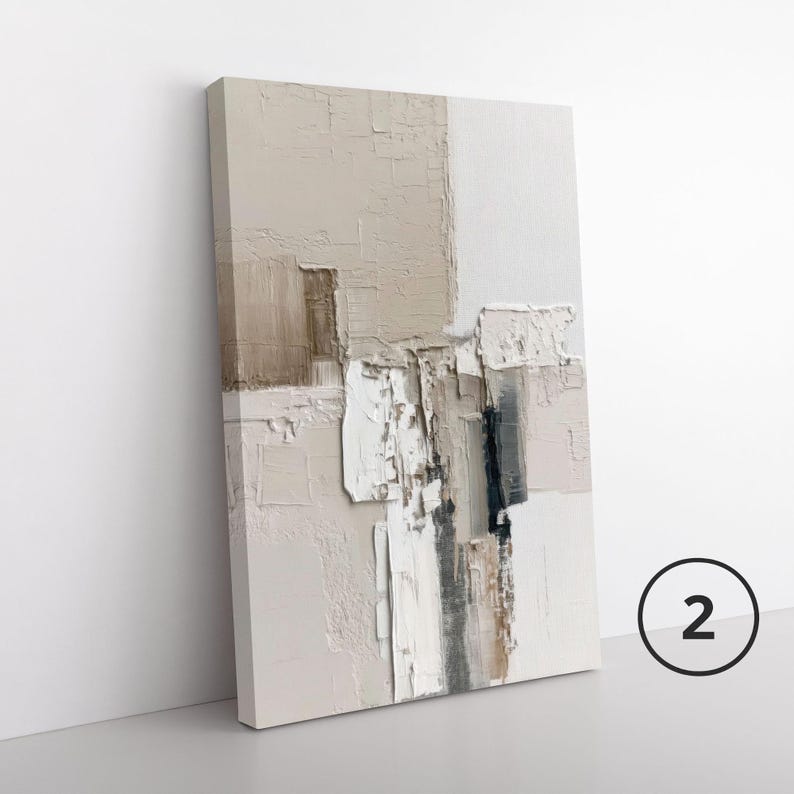 May include: A rectangular canvas wall art piece featuring an abstract composition with thick, textured paint application. The color palette consists of neutral shades including beige, cream, white, and dark gray, arranged in layered, blocky shapes.