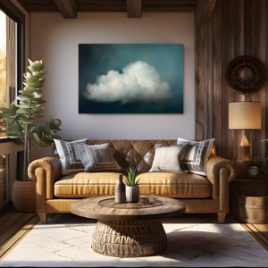 Puede incluir: Un sof&aacute; de cuero marr&oacute;n con dos almohadas y una mesa de caf&eacute; de madera delante de &eacute;l. Una pintura de una nube blanca sobre un fondo azul oscuro cuelga en la pared detr&aacute;s del sof&aacute;.