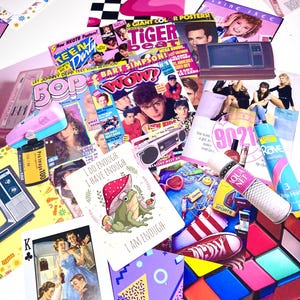 May include: A collection of vintage magazines, playing cards, and stickers with a retro aesthetic. Includes magazines like Tiger Beat and Bop, a Rubik's Cube, and a card with a frog illustration. The color palette is bright and nostalgic.