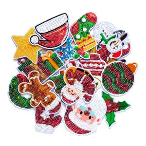 May include: A selection of Christmas patches with sequin embellishments. Designs include a Santa hat, stocking, snowman, baubles, star, gift, gingerbread man, wreath, and Santa Claus face. The patches are in red, green, white, and gold.