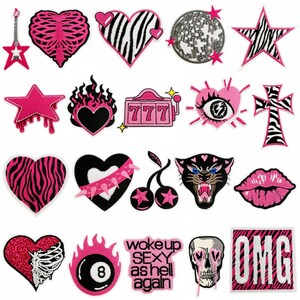 May include: A selection of pink and black embroidered patches. Designs include hearts, stars, a skull, a panther, a disco ball, and text that says "woke up SEXY as hell again" and "OMG".