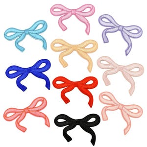 May include: A selection of embroidered bow appliques in a range of colours: pink, blue, purple, yellow, red, and black. Each bow has a detailed stitched design and flowing ribbon ends, ideal for craft projects.