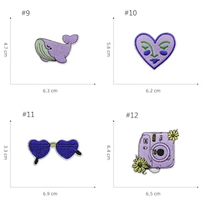 May include: Four iron-on patches with different designs. A purple whale with green accents, a purple heart with a face, purple heart-shaped sunglasses, and a purple camera with yellow flowers. The patches are approximately 6 cm wide and 6 cm tall.