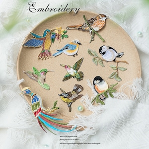 May include: Assortment of colourful embroidered bird patches. The patches feature various bird species, including hummingbirds, robins, and sparrows. The patches are perfect for adding a touch of nature to clothing, bags, or other crafts.