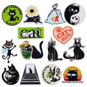 May include: A collection of embroidered patches featuring various black cat designs. The patches include text like "I'm not a sloppy kitten", "Eat", and "Cat Mom". Other designs include a yin-yang cat, a cat with sunglasses, and a cat with a candle.