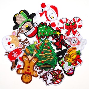 May include: A selection of embroidered Christmas patches in various festive designs. Features a snowman, Christmas tree, candy cane, reindeer, gingerbread man, and a penguin in a Santa hat. The patches are in red, green, white, and brown.