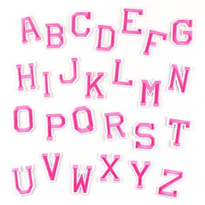 May include: Pink felt letter patches in uppercase, A through Z. The letters are outlined in white.