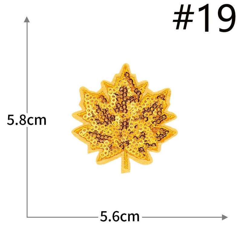 Pu&ograve; includere: Una toppa a forma di foglia d'acero con paillettes dorate etichettata #19. La toppa presenta una disposizione densa di piccole paillettes dorate riflettenti su una base in tessuto. Le linee di misura indicano 5,8 cm di altezza e 5,6 cm di larghezza.