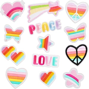 May include: A set of 12 iron-on patches featuring rainbow designs. The patches include hearts, stars, butterflies, peace signs, and the words "LOVE" and "PEACE".