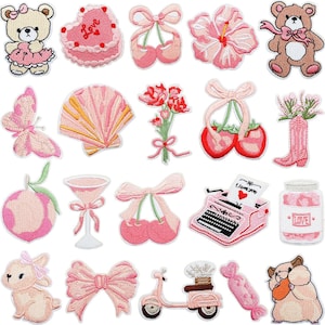 May include: A selection of embroidered patches in pink and beige. Designs include a teddy bear, heart-shaped cake, ballet slippers, hibiscus flower, butterfly, seashell, bouquet, cherries, cowboy boot, peach, martini glass, typewriter with "I love you" text, jar, bunny, bow, scooter, candy, and hamster.