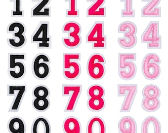 May include: Embroidered number patches in black, hot pink, and light pink. Each number is outlined in white. Numbers 1 to 0 are displayed in various styles, ideal for personalising clothing or accessories.
