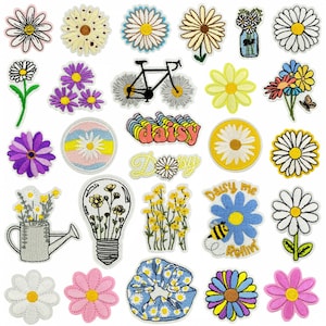 May include: A collection of embroidered daisy patches in various colors and designs. Includes patches with text like "Daisy me Rollin'" and "Daisy". Features a bicycle, watering can, and lightbulb designs.
